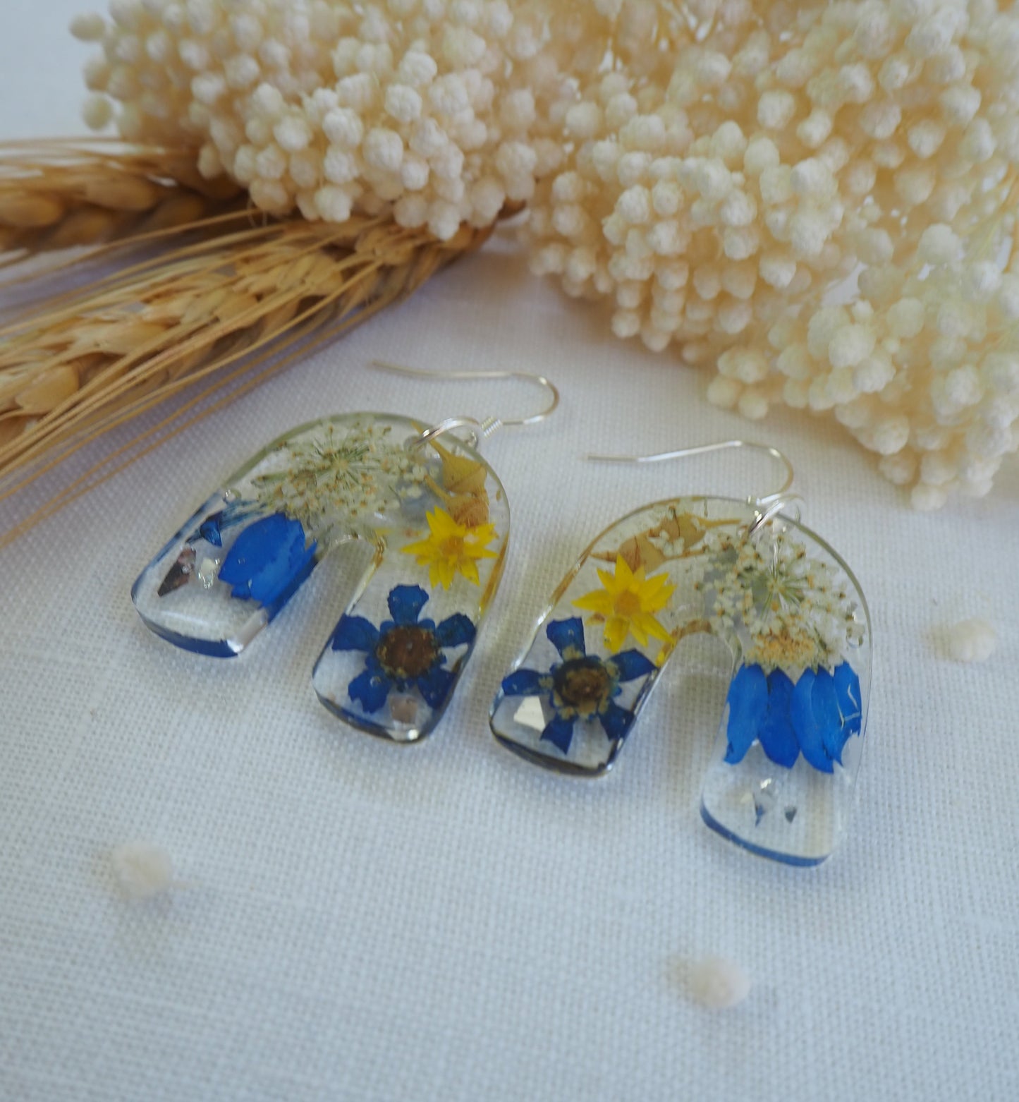 Vibrant blue floral arch earrings